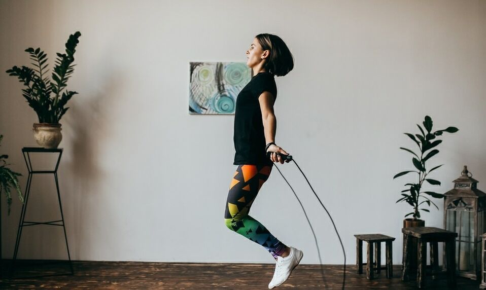 girl doing an exercise with a rope